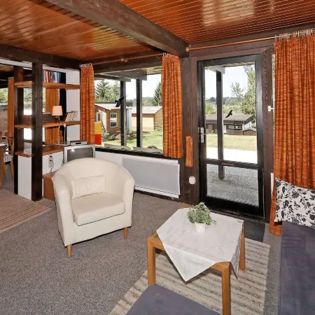 Wooden Chalet with Terrace Near Swimming Lake