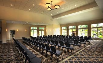 a large conference room with rows of chairs arranged in a semicircle , ready for an event at Atkinson Resort & Country Club