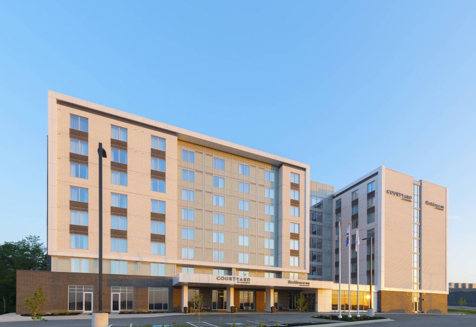 a large , modern hotel building with multiple floors and balconies , situated in front of a parking lot at Residence Inn Halifax Dartmouth