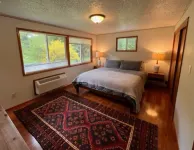 Private mid-century modern hideaway in forest near the river and sea.