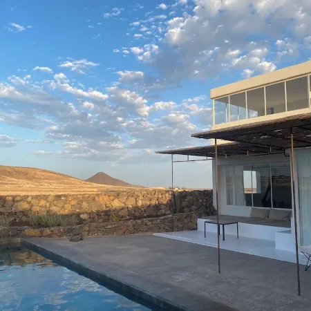 An architectural oasis with large swimming pool, along a breath-taking scenery.