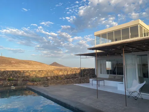 An architectural oasis with large swimming pool, along a breath-taking scenery.