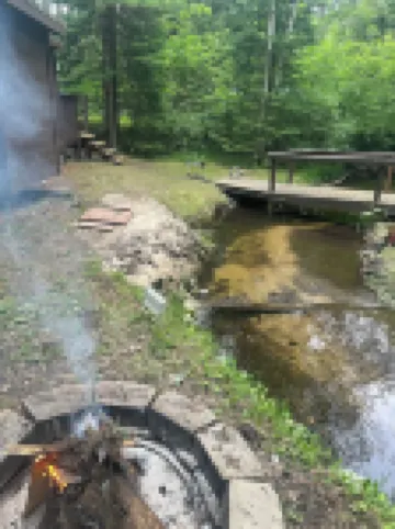 A Stream  runs through it. Comfy little cabin with a stream by your bedroom.