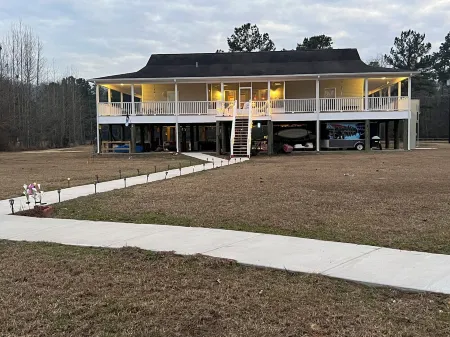 Accessible lake-front 4 bedroom home with TONS of outdoor covered space!