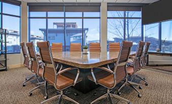 a conference room with a large table and chairs , surrounded by windows overlooking the city at Newpark Resort