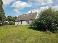 Holiday house with a large garden and swimming lake in the village