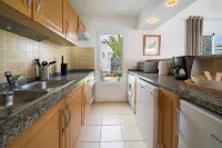 B1, in a small complex with communal heated pool 100m from the sea