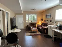 Lrg 1 bdrm ground level suite with a Private Entry in a forest setting.