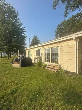 Lakeside Sunsets at this 3-bedroom lake cottage that sleeps 12 on Secord Lake.