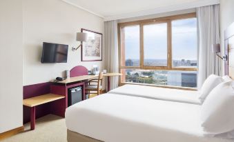 a hotel room with a large window offering a view of the city , a bed , desk , and chair at Abba Garden