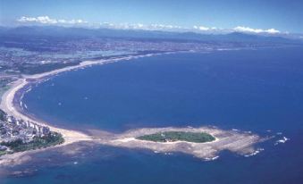 a bird 's eye view of a large body of water with a small island in the middle at Hotel Wing International Miyakonojo