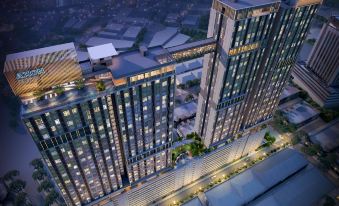 An aerial view at night reveals a spacious building adorned with numerous windows at Sleeping Lion Suites