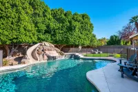 Expansive Backyard Oasis with Pool and Waterslide - Inviting Escape