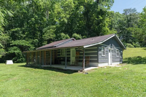 Moonshine Cabin with a nice yard on the creek in the shadows of the Smokies