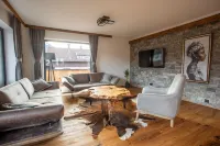 Modern chalet with a wraparound balcony with majestic views of the mountains