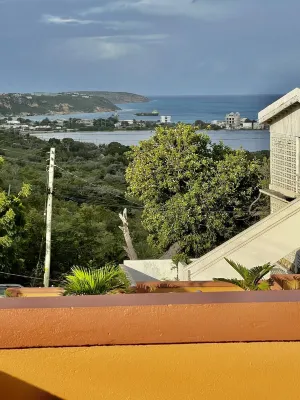 A colored beacon sitting on the hill side road that leads into Sandy Ground, Hotels in Sandy Ground