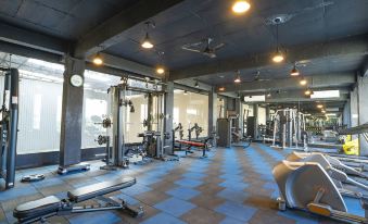 a well - equipped gym with a variety of exercise equipment , including weight machines and cardio machines at The Park