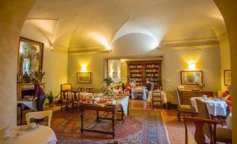 a large dining room with wooden tables and chairs arranged for a group of people to enjoy a meal together at Hotel Villa Sermolli