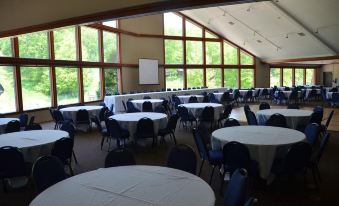 a large room with tables and chairs set up for a formal event , possibly a wedding or conference at Devil's Head Resort