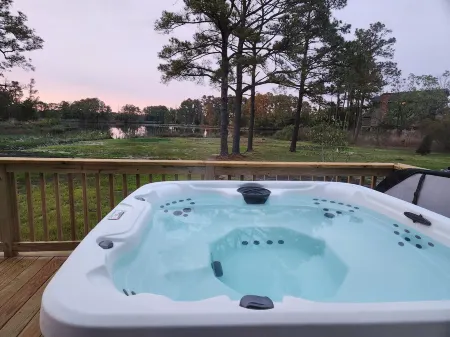 Secluded waterfront getaway with hot tub,fire pit, and private dock.