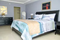 Gated 1-bedroom Condo in Portmore with AC, WiFi, Pool, Kitchen, TV, Beach View