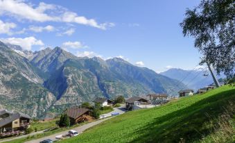 a picturesque mountain village with a small village nestled in the valley , surrounded by lush green hills at Chalet Ninette