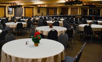 a large dining room with round tables and chairs arranged for a formal event , possibly a wedding reception at Daniels Summit Lodge