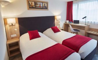 a hotel room with two twin beds , a desk , and a tv , decorated in a modern style at Kyriad Lille Est - Hem