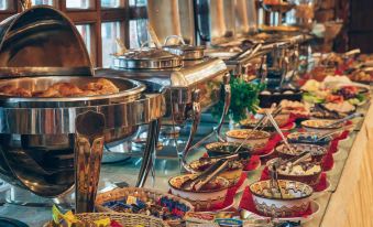 a large buffet table filled with a variety of food , including meats , vegetables , and desserts at Hotel Super 8