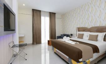 a large bed with a brown and white striped comforter is in the middle of a room at Victoria Inn