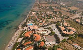aerial view of a large resort complex near the ocean , featuring multiple buildings and a beach at La Plage Resort