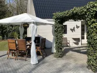 A Detached Bungalow with Outdoor Fireplace Covered Terrace and Pond in a Forest Plot Hotels in 