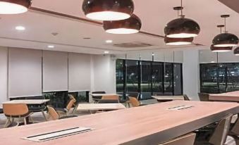 a large , empty conference room with multiple tables and chairs arranged for a meeting or event at Fortune Hotel Buriram