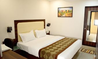 a neatly made bed with a brown and green blanket is shown in a hotel room at Lime Tree Hotel