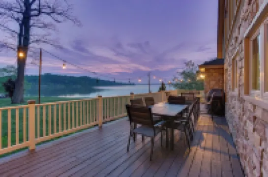 Stunning waterfront villa with indoor pool and kids swing set and play area.