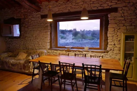 Stone house with garden, barbecue and fireplace.