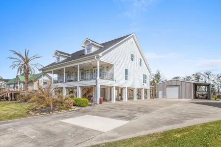 Luxury riverfront home w/ pool, fishing dock, & boat house w/ lift ! Sleeps 14