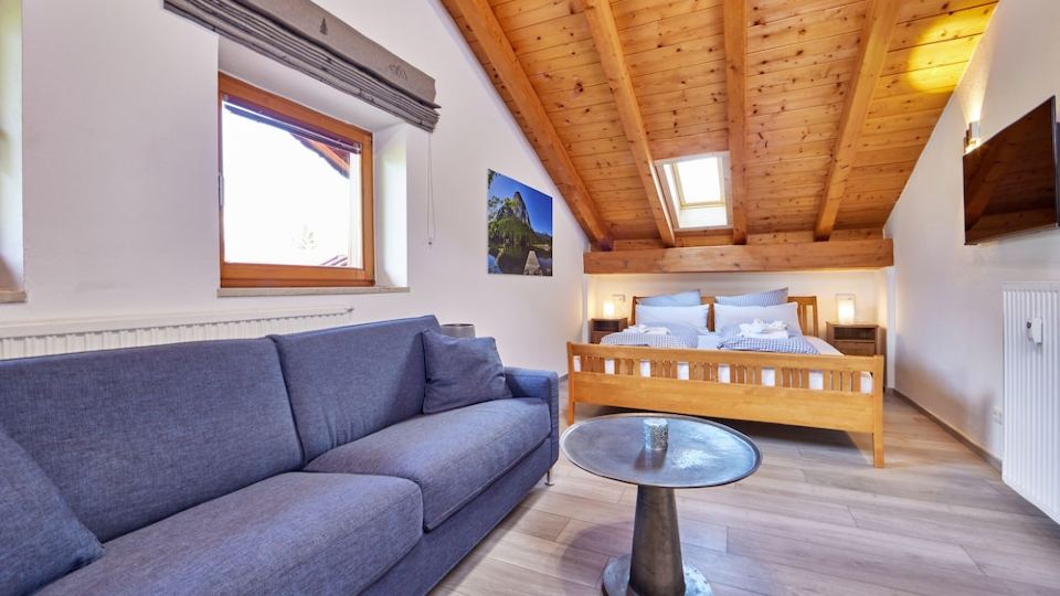 Individual 40 sqm attic apartment with open roof truss and balcony access