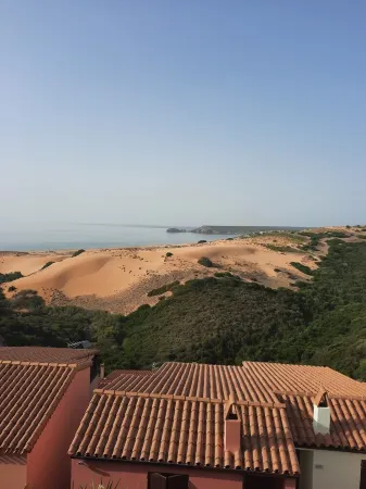 Dimidium Apartment Отели рядом с достопримечательностью «Spiaggia Le Dune di Piscinas»