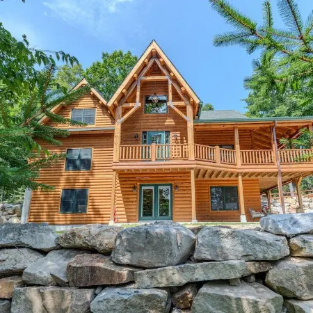 Luxury Log home steps from private beach in Meredith on Lake Winnipesaukee.