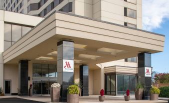 the entrance to a marriott hotel with a large sign above the door and several potted plants on either side at Tysons Corner Marriott