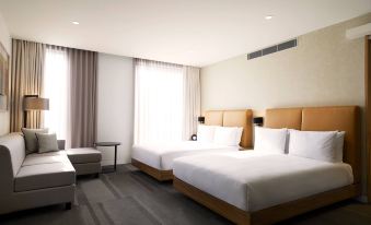 a modern hotel room with two beds , white bedding , and a window offering a view of the city at Hyatt Place Melbourne Essendon Fields