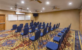 a conference room with rows of chairs arranged in a semicircle , ready for a meeting at Holiday Inn Canyon de Chelly (Chinle)