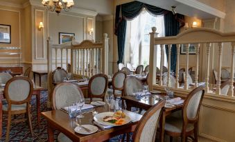 a dining room with tables and chairs arranged for a group of people to enjoy a meal together at Best Western Lamphey Court Hotel