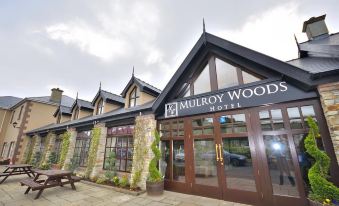 "a large building with a brown door and windows , and the name "" mutroy woods hotel "" is displayed above the entrance" at Mulroy Woods Hotel