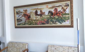a room with a couch and two chairs , along with a painting on the wall at Hotel Nguyen Ngoc