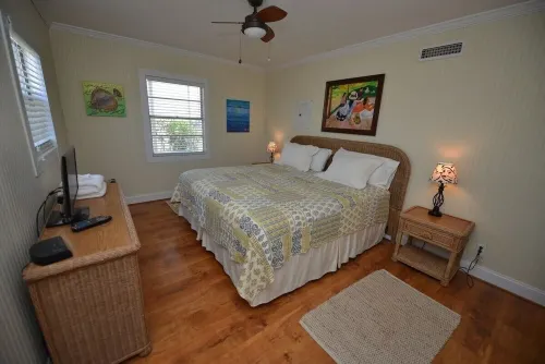 TROUT Steps to beach. Lovely two bedroom with screened porch and pool.