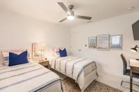 Chic Coastal Bungalow with Fire Pit, Lanai, Games & Fully Fenced Yard