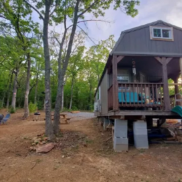 Cozy tiny cabin nested in the trees in a lake community, peaceful countryside.