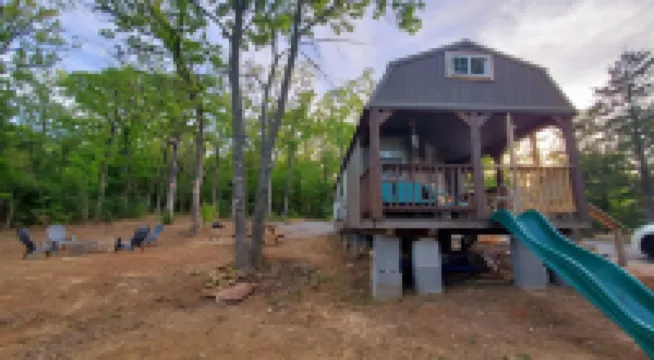 Cozy tiny cabin nested in the trees in a lake community, peaceful countryside.